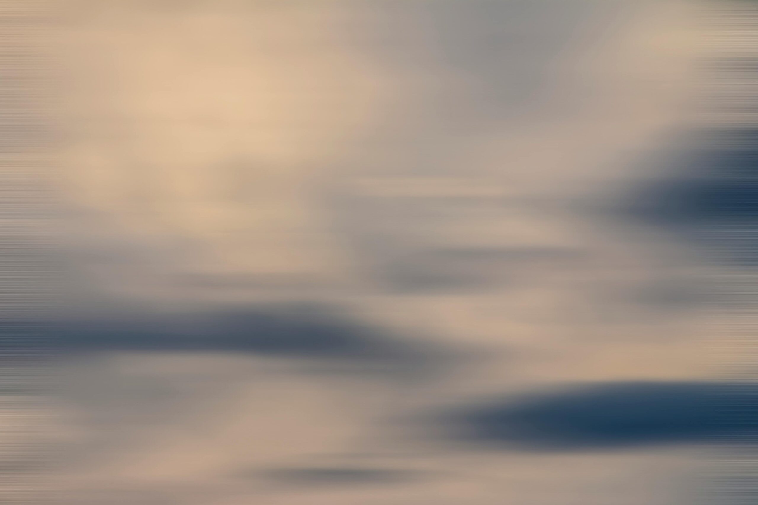 Soft focus depiction of a pastel sky with blurred clouds, evoking a dreamy atmosphere.